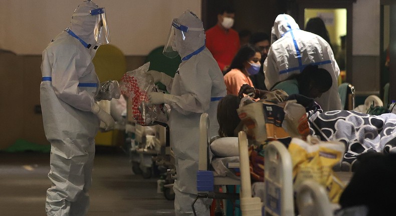 Medics attend to COVID-19 patients at Shehnai Banquet Hall, temporarily converted into an isolation ward, as coronavirus cases surge across the country.
