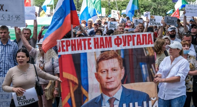 Protestors in the Russian Far East city of Khabarovsk  carry a banner reading Return Furgal for us, during an unauthorised rally Saturday in support of Sergei Furgal