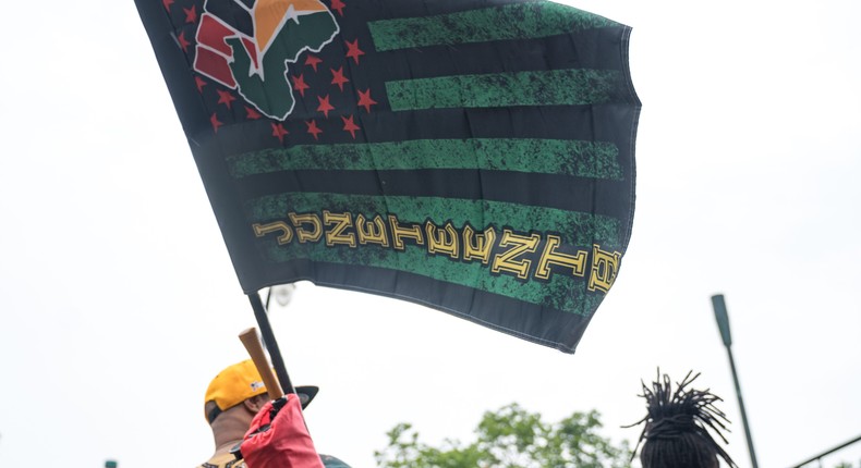 People watch a parade taking place to celebrate Juneteenth 2021 in Atlanta, Georgia.