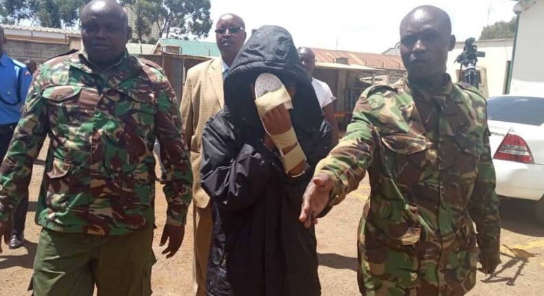 Naftali Njahi Kinuthia escorted by police to his first court appearance following murder of Ivy Wangechi (Twitter)