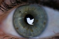 An illustration picture shows the Twitter logo reflected in the eye of a woman in Berlin