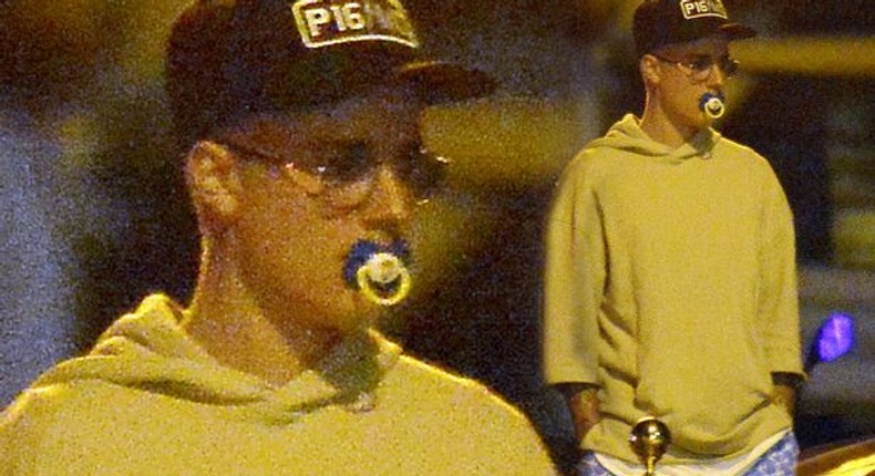 Justin Bieber sucking on a pacifier