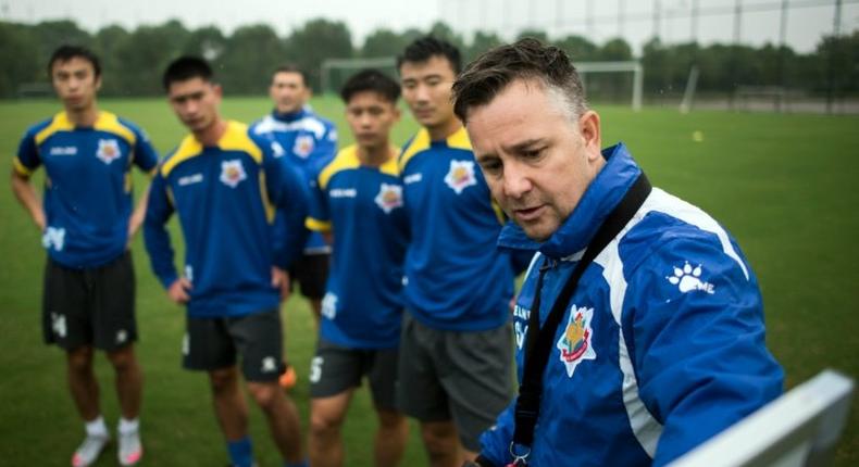 Gary White (R) has his eye on winning promotion to the Chinese Super League next season after saving Shanghai Shenxin from relegation