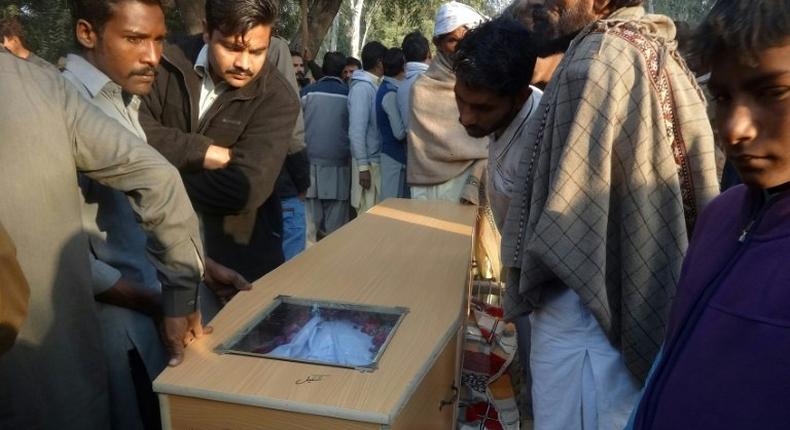 Pakistani Christians carry a coffin for one of the victims who was killed by toxic liquor, during his funeral in Toba Tek Singh, central Pakistan, on December 27, 2016
