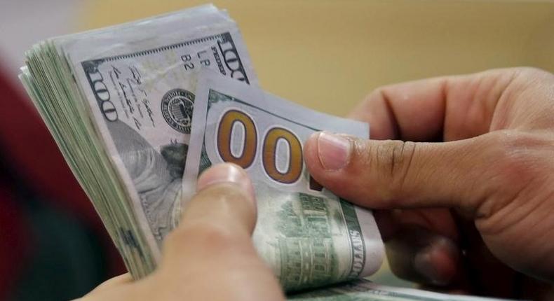 A customer counts his U.S. dollar money in a bank in Cairo, Egypt  March 10, 2016. E REUTERS/Amr Abdallah Dalsh/File Photo