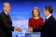 French politicians Alain Juppe and Nicolas Sarkozy shake hands as Nathalie Kosciusko-Morizet looks 