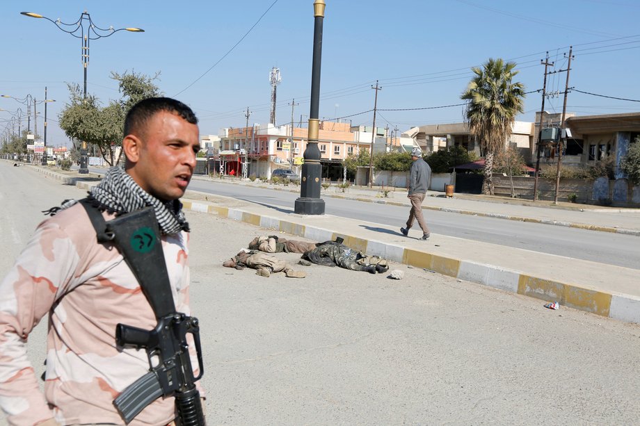 An Iraqi soldier with his weapon near corpses of ISIS militants killed in clashes in Mosul, February 6, 2017.