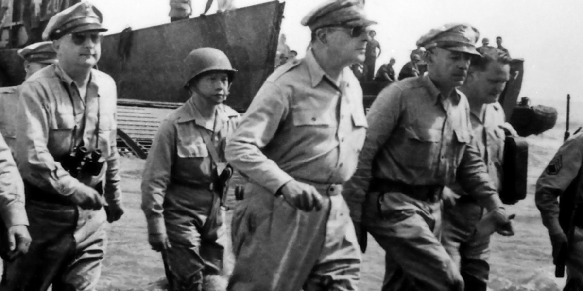 General Douglas MacArthur wades through the water after landing on a beach in the Philippines in 1944.