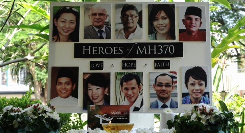 A poster showing cabin crew from missing Malaysia Airlines flight MH370 is displayed during a prayer at a school in Petaling Jaya 