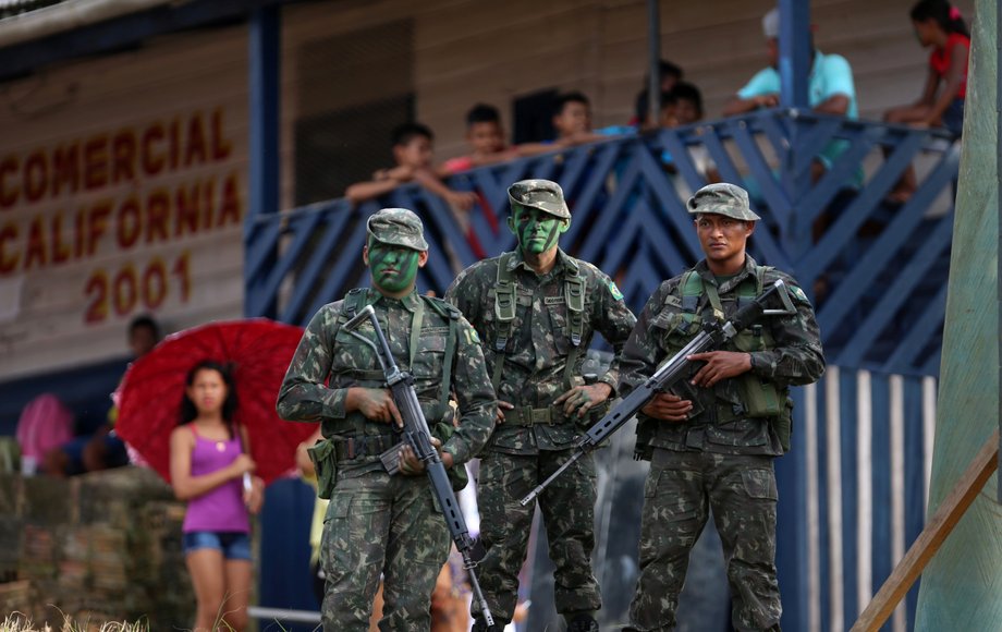 Brazilian soldiers pose for a picture as they patrol the border with Colombia during a training to show efforts to step up security along borders, in Vila Bittencourt, Amazon State, January 18, 2017.