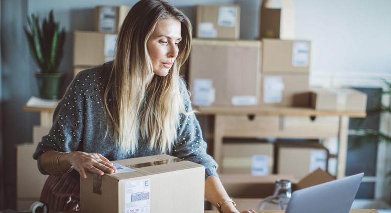 A woman working at an online shop checking order information.
