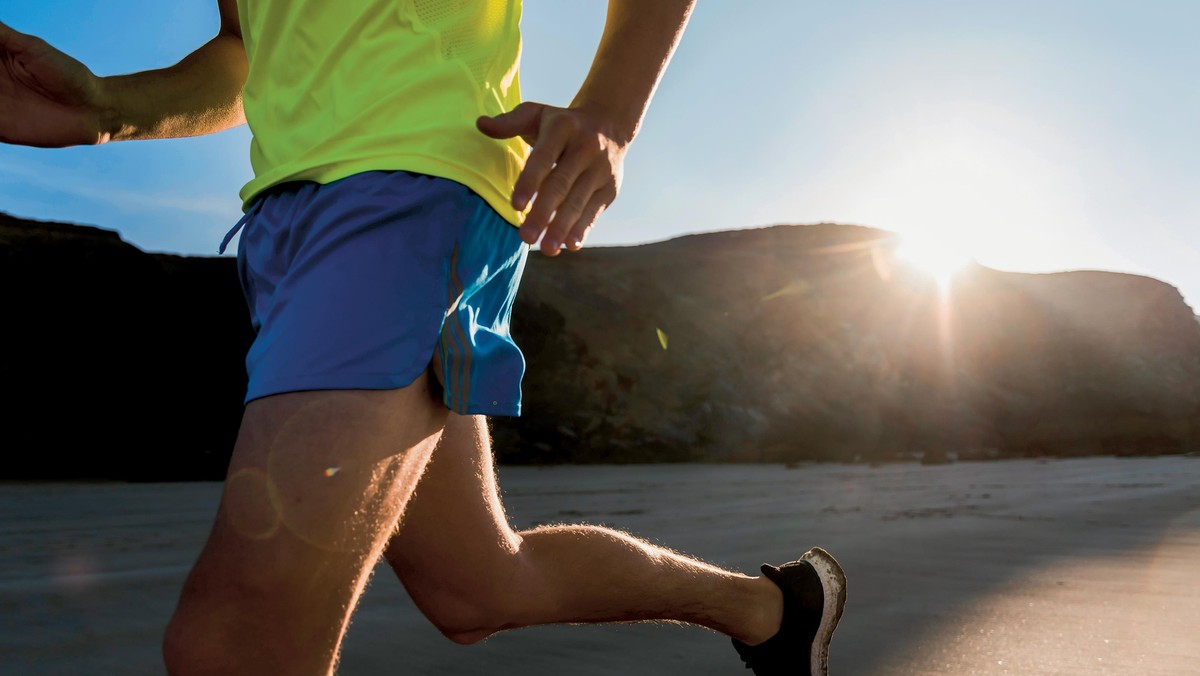 France, Crozon peninsula, young man running on the beach