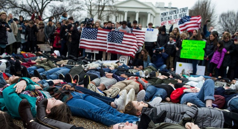 Demonstrators lie on the ground a 'lie-in' demonstration supporting gun control reform near the White House on February 19, 2018 in Washington, DC.