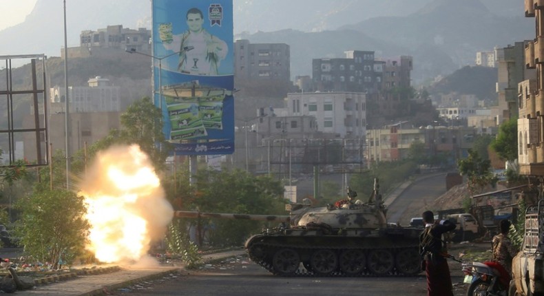 Yemeni fighters loyal to exiled President Abedrabbo Mansour Hadi fire from a tank during clashes with Shiite Huthi rebels in the country's third-city of Taez