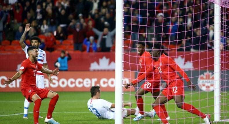 Alphonso Davies (12) celebrates firing Canada into the lead in their upset victory over the United States