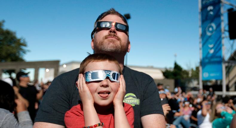 Dan Blanchette and his son, Sam, 6, watching the final phases of a total solar eclipse in Salem, Oregon.