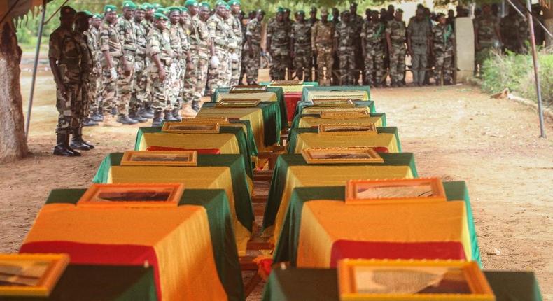 Coffins of Malian army officers killed in an attack are displayed on July 21, 2016 in Segou during a funeral ceremony 