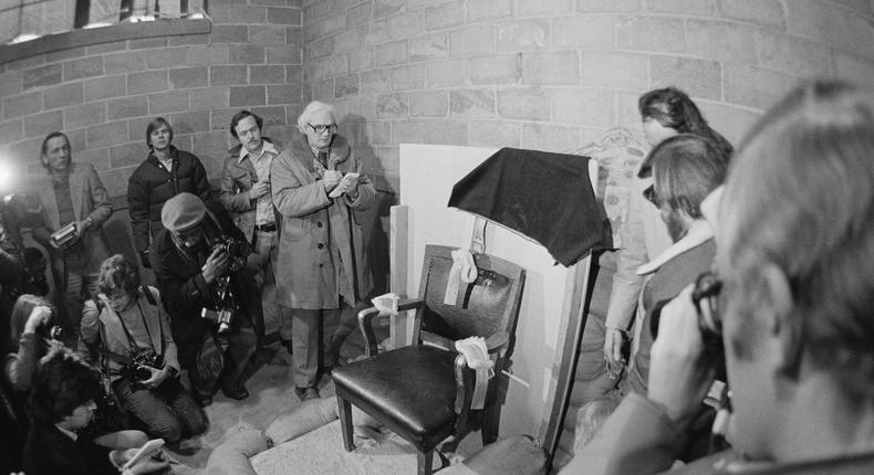 A group of newsmen looking at the chair in which Gary Gilmore sat when facing the firing squad on January 17, 1977, in Point of the Mountain, Utah.Bettmann / Getty