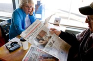 Vicki, left, and Dan Rubin look at the final edition of the