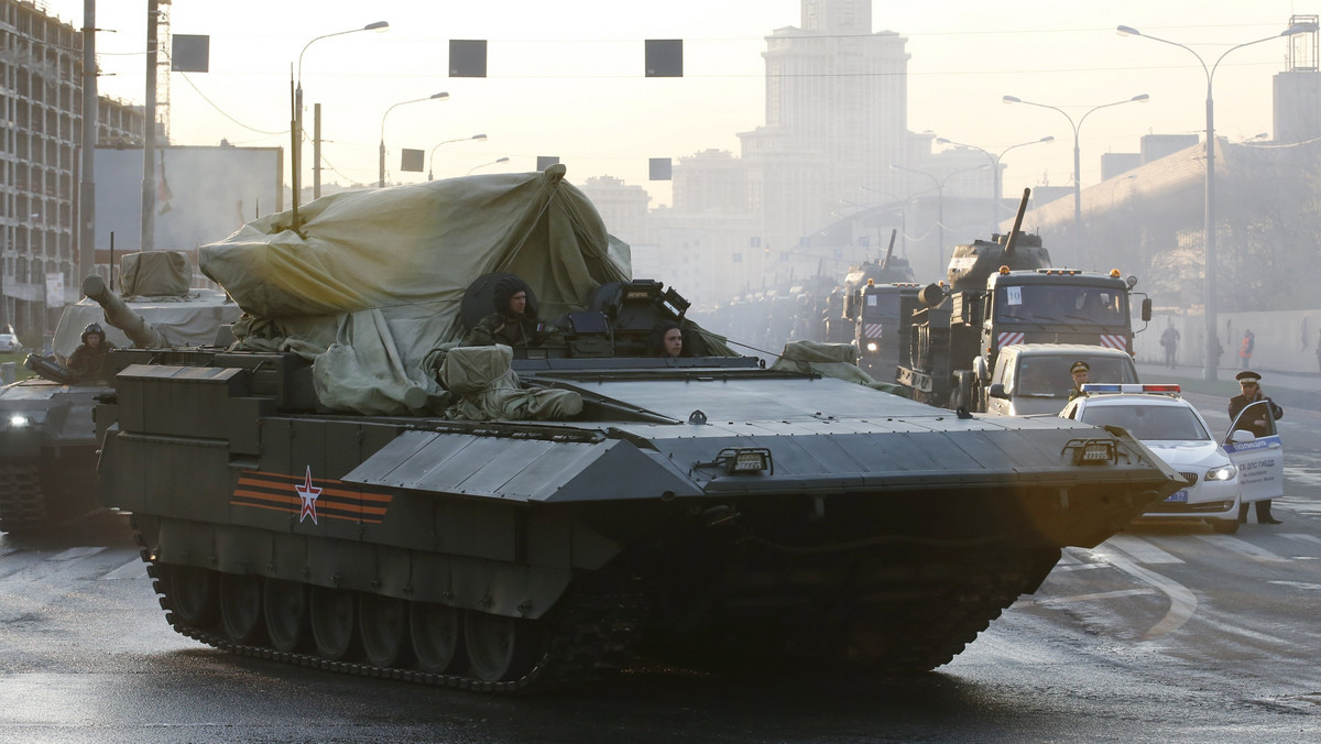 A partially covered T-15 heavy IFV drives along a street before a rehearsal for the Victory Day parade in Moscow