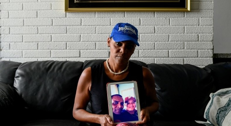 Yamileth Marcano shows a picture of her brother who was stabbed to death for his smartphone, becoming one of the thousands murdered in crisis-hit Venezuela