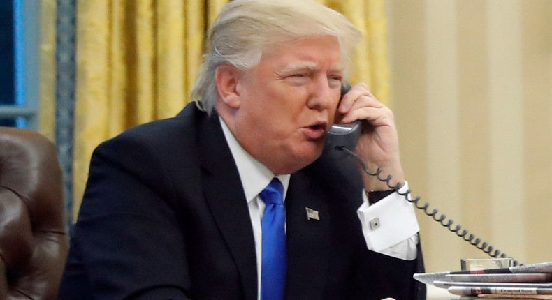 U.S. President Donald Trump speaks on the phone with Prime Minister of Australia Malcolm Turnbull in the Oval Office of the White House, Saturday, Jan. 28, 2017 in Washington.