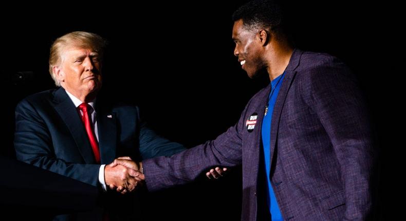 Former President Donald Trump shake hands with Herschel Walker at a Save America rally at the Georgia National Fairgrounds in Perry, Ga., on September 25, 2021.Demetrius Freeman/The Washington Post via Getty Images