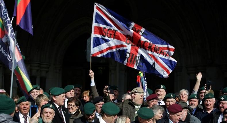 Supporters of former British soldier Alexander Blackman, react outside The Royal Courts of Justice after his sentence was reduced from murder to manslaughter