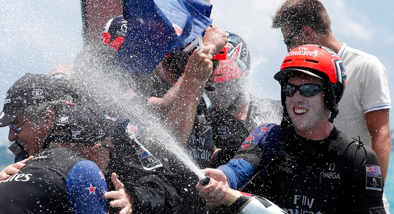 Peter Burling, the helmsman of Emirates Team New Zealand, right, after beating Oracle Team USA in race nine to win the America's Cup.