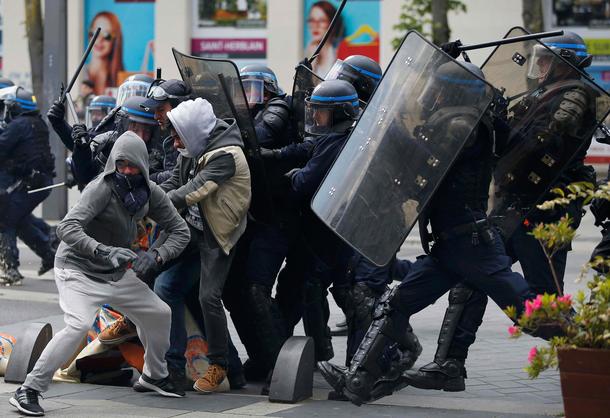 French riot police officers clash with protestors during a demonstration against the French labour l