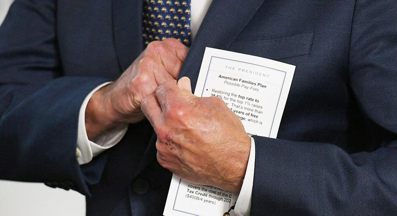 President Joe Biden holds a note card before delivering remarks. His use of cheat sheets has recently sparked some concerns from donors, according to a report.Mandel Ngan/AFP via Getty Image
