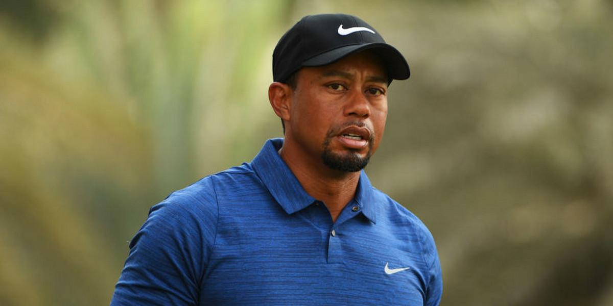 Police report says Tiger Woods was found asleep in his car before being charged with DUI
