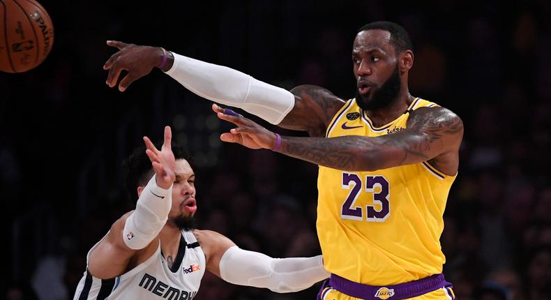 Los Angeles Lakers forward LeBron James, right, passes while under pressure from Memphis Grizzlies guard Dillon Brooks during the first half of an NBA basketball game Friday, Feb. 21, 2020, in Los Angeles. (AP Photo/Mark J. Terrill)