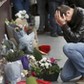 A man pays his respect outside the Le Carillon restaurant the morning after a series of deadly attacks in Paris