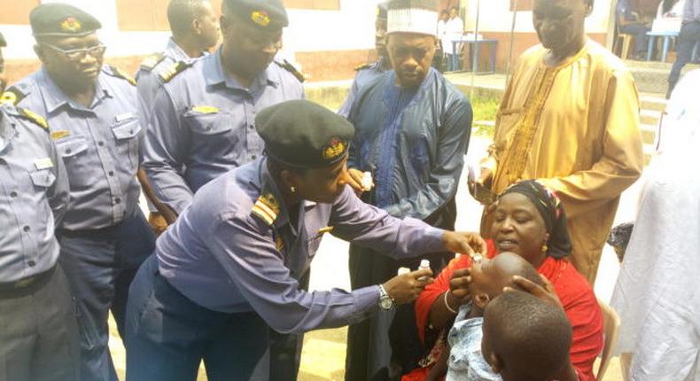 Ag Commander of Nigerian Navy Reference Hospital Calabar, Surgeon Commander Uche Okeke, de-worming a child during the Navy medical outreach in Nassarawa community in Calabar Municipality