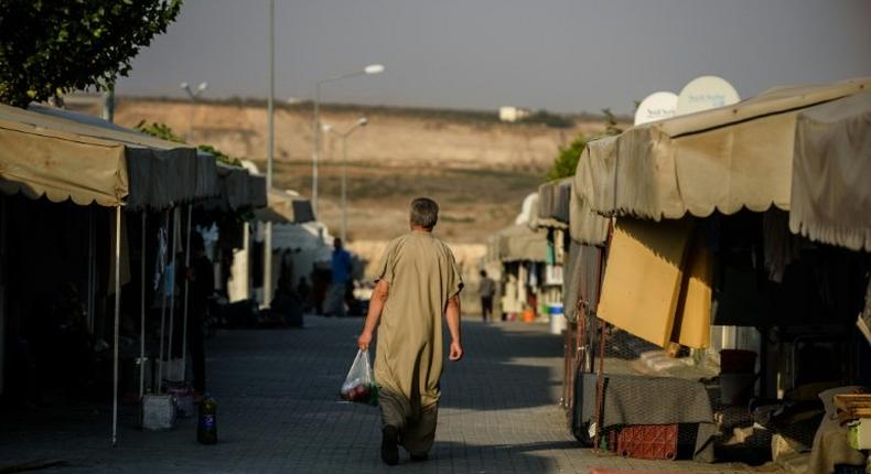 A Syrian man walks at a refugee camp in the Kilis district of Gaziantep, southeastern Turkey, on October 23, 2016