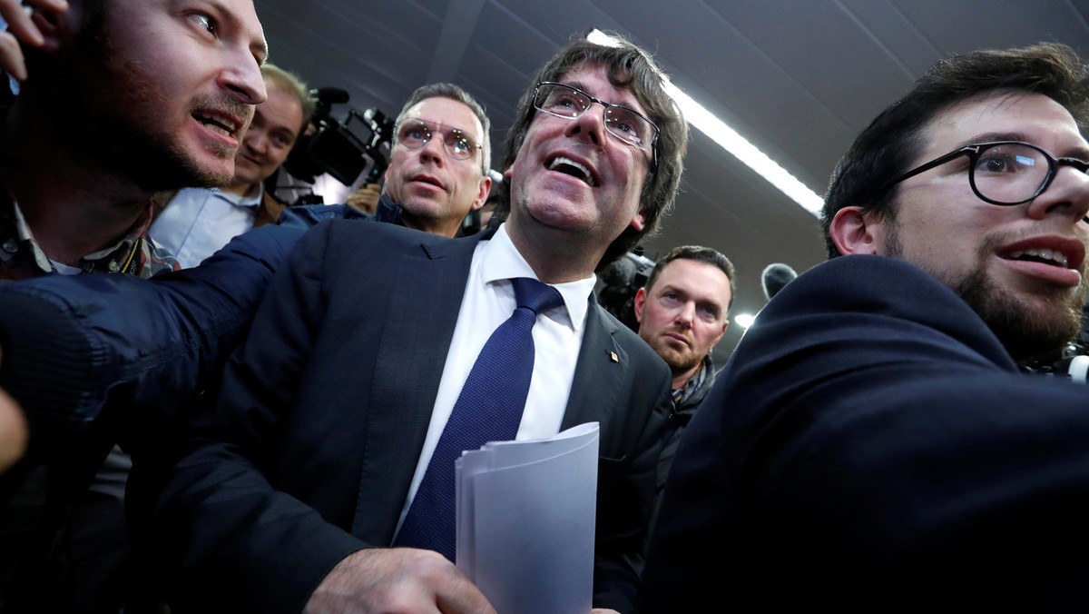 Sacked Catalan leader Carles Puigdemont departs after a news conference in Brussels