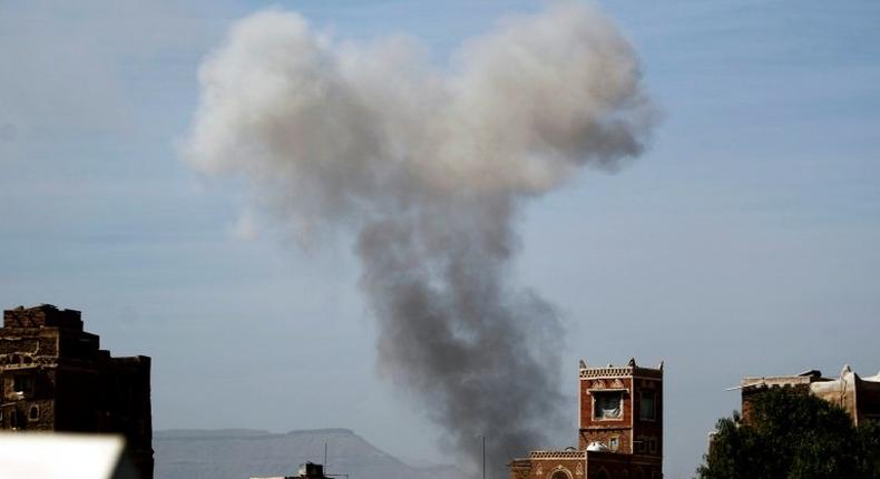 Smoke billows behind a building following a reported air strike by the Saudi-led coalition in the Yemeni capital Sanaa on January 22, 2017