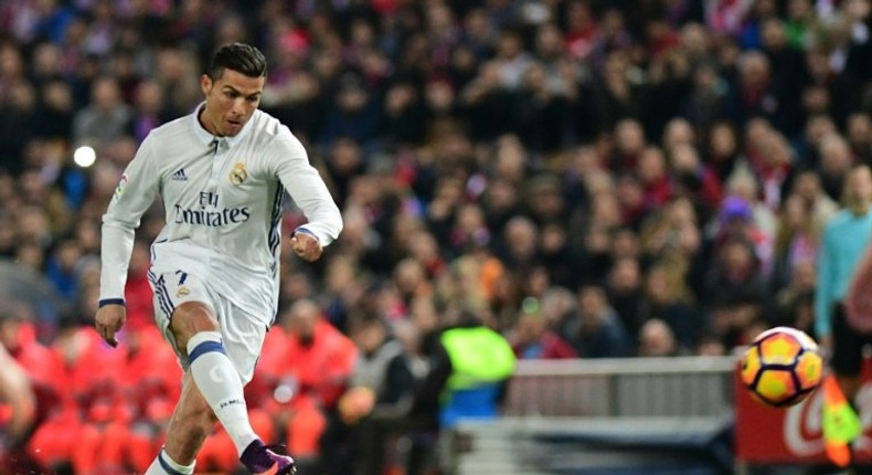 Real Madrid's Cristiano Ronaldo scores during the match agaisnt Club Atletico de Madrid on November 19, 2016