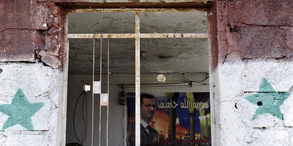 Syria's President Bashar Assad is seen inside a checkpoint at the site of a car bomb on the outskirts of the Sayeda Zeinab district south of Damascus, Syria, April 25, 2016.