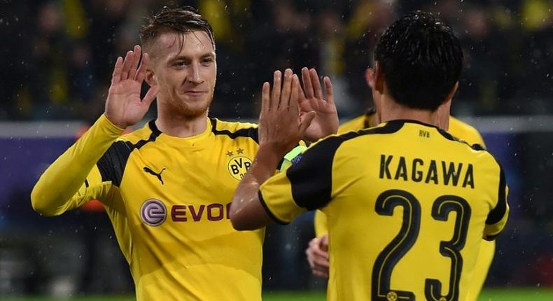 Dortmund's striker Marco Reus (L) and midfielder Shinji Kagawa celebrate during a Champions League football match against Legia Warsaw on November 22, 2016