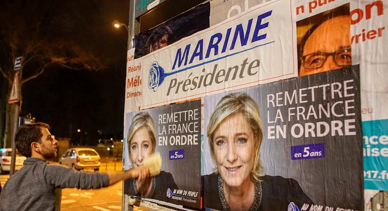 Members of the National Front youths put up posters of Marine Le Pen, French National Front (FN) political party leader and candidate for the French 2017 presidential election, ahead of a 2-day FN political rally to launch the presidential campaign in Lyon, France, February 2, 2017