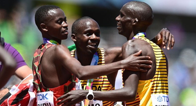 EUGENE, OREGON - JULY 17: Gold medalist Joshua Cheptegei of Team Uganda, silver medalist Stanley Waithaka Mburu of Team Kenya and bronze medalist Jacob Kiplimo of Team Uganda celebrate after the Men's 10,000m Final on day three of the World Athletics Championships Oregon22 at Hayward Field on July 17, 2022 in Eugene, Oregon. (Photo by Hannah Peters/Getty Images for World Athletics)