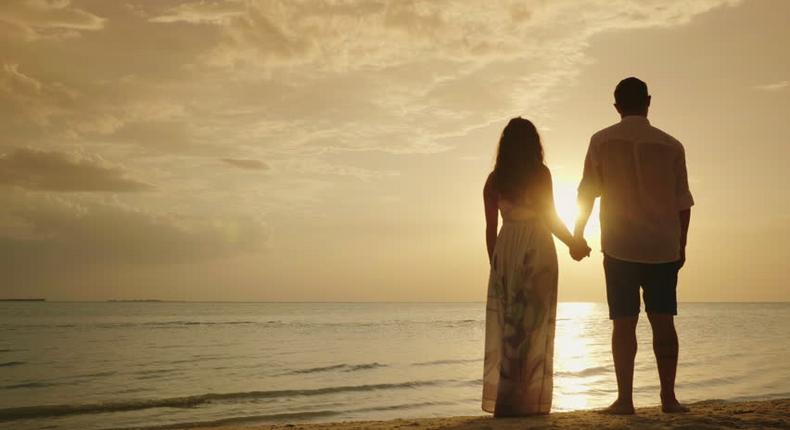 Stock photo of a couple's silhouette on a beach [Credit - Shutterstock]