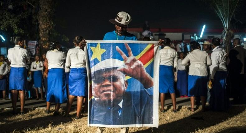 A supporter of the Democratic Republic of Congo's opposition leader Etienne Tshiskedi holds his portrait during a rally in Kinshasa in 2016