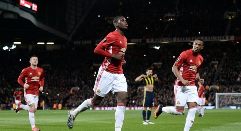 Manchester United's French midfielder Paul Pogba (C) celebrates scoring their first goal from the penalty spot against Fenerbahce at Old Trafford in Manchester, north west England, on October 20, 2016