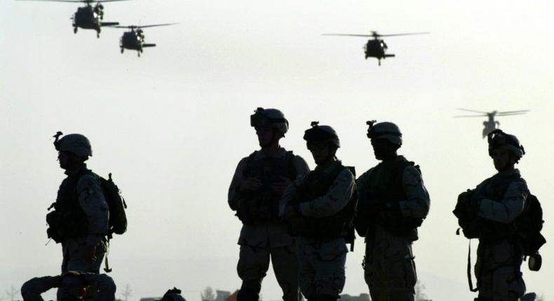 American soldiers wait to board helicopters at Kandahar airbase in Afghanistan in 2003