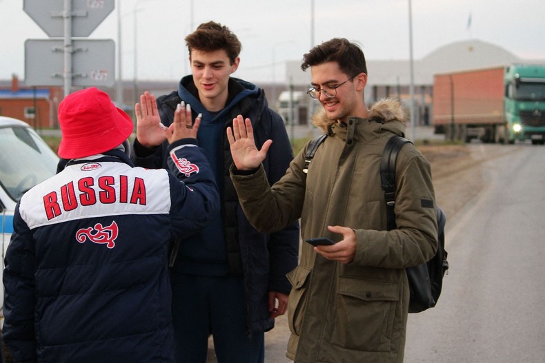 A volunteer welcomes Russians to Kazakhstan at a border crossing on September 27.STRINGER/AFP via Getty Images