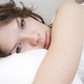 brunette curl woman lying on the bed