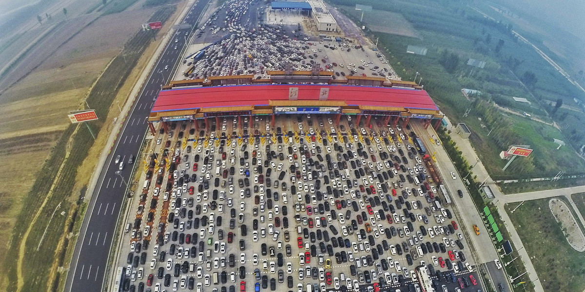 Vehicles are seen stuck in a traffic jam near a toll station, as people return home at the end of a weeklong national day holiday, in Beijing, China.